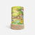 A cylindrical table lamp with a light wood base and a printed fabric shade featuring a whimsical garden scene with a pear cart, flowers, and a bird, shown on a plain light gray background.
