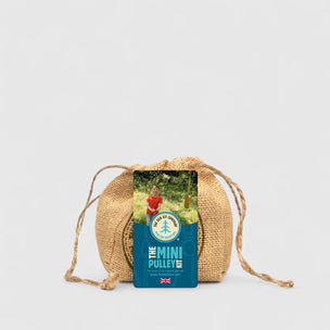 Wicker bag with a card labeled 'The Mini Pulley' on a light gray background