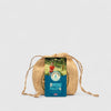 Wicker bag with a card labeled 'The Mini Pulley' on a light gray background