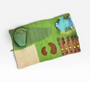 Colorful felt Tara Treasures  play mat with farm design on a white background