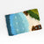 Felted play mat with a beach design on a white background