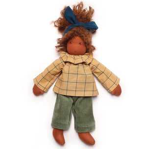 Doll wearing a yellow checkered coat and green pants on a white background