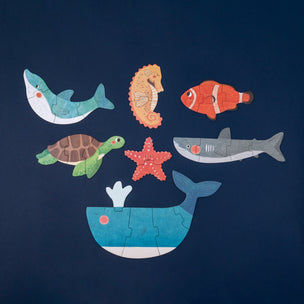Set of sea-themed puzzle pieces on a dark blue background