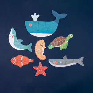 Set of ocean-themed puzzle pieces on a navy background
