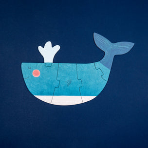 Whale-shaped puzzle on a dark blue background