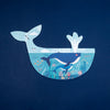 Illustration of a whale with an underwater scene inside on a dark blue background