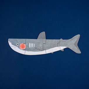 Shark-shaped puzzle on a blue background