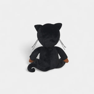 Black plush toy cat on a light gray background