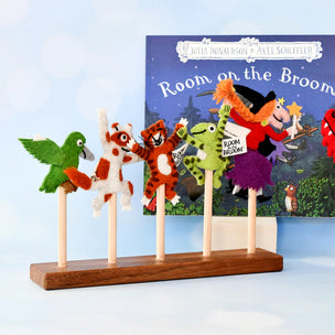 Felt character puppets on sticks with a 'Room on the Broom' book in the background.