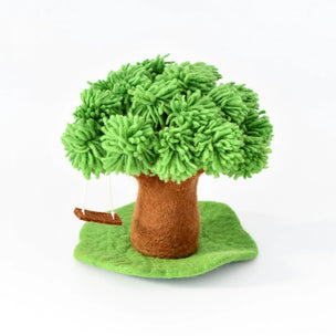 A small felt tara treasures tree decoration with bright green textured foliage, a brown trunk, a green base, and a hanging brown swing, photographed on a clean white background.
