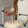 Young girl playing a musical instrument with colorful lettering