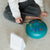 Child playing with a colorful drum on a beige carpet
