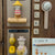 Wooden toys and decorative items on a wooden surface with 'The Fisherman' and 'The Honey Gatherer' labels.
