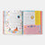 Open book showing colorful pages with text and illustrations on a white background