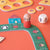 Children's board game with a character figure and dice on an orange surface