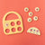 Wooden toy with various shaped pieces on a pink background