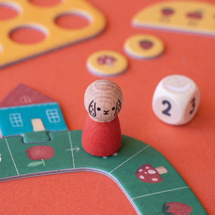 Board game piece and dice on a colorful game board with a red background