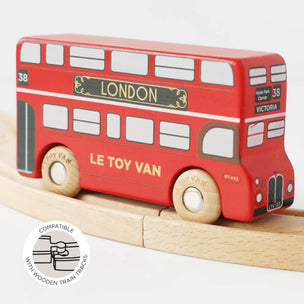 Red toy bus with 'Le Toy Van' branding on a wooden track.