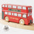 Red toy bus with 'Le Toy Van' branding on a wooden track.