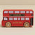 A red wooden toy double-decker bus with 'LONDON' and 'LE TOY VAN' lettering, shown on a plain beige background.