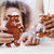 Two plush toys resembling characters from 'The Gruffalo' held by children.