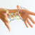 hands playing with colourful string