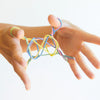 hands playing with colourful string