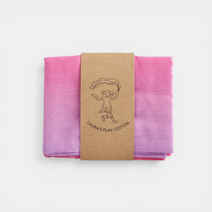 Laura's cotton play cloth unicorn fabric folded with a brown label on a white background