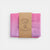 Laura's cotton play cloth unicorn fabric folded with a brown label on a white background