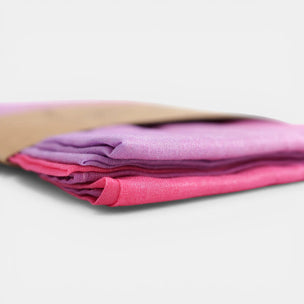 Laura's Play Cotton - Stack of pink and purple fabric on a white background