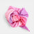 Pink and purple fabric flower on a light gray background