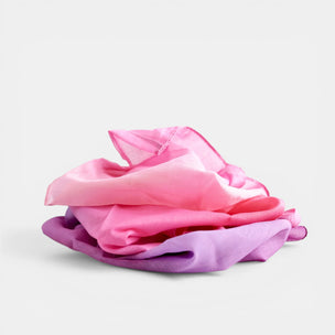 Pink and purple Laura's Cotton Play Cloth on a light gray background