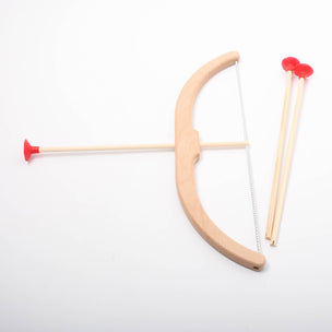 Wooden bow and arrow set with red nocks on a white background