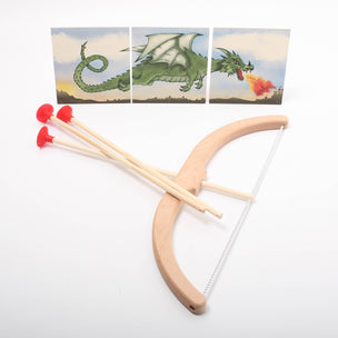 Wooden slingshot with red rubber bands on a white background, with images of dragons in the corner.