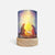 A cylindrical LED candle lamp with a light wood base, featuring a printed graphic of the Holy Family under a glowing star.