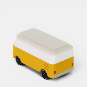 Yellow and white bus-shaped van on a light gray background