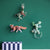 Decorative animal wall art on a green wall with a shelf below.