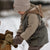 Child in winter clothing interacting with teddy bears in a snowy setting