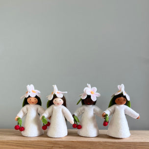 4 felt Cherry Flower Fairies wearing white dresses and Cherry flowers on their heads with varied skin tones holding cherries | © Conscious Craft
