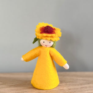A felt Firewheel Flower Fairy wearing golden yellow dress and firewheel flower on her head with light skin tone | © Conscious Craft