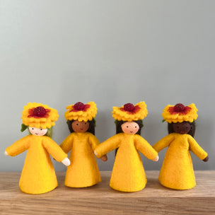 4 felt Firewheel Flower Fairies wearing golden yellow dresses and firewheel flower on their heads with varied skin tones | © Conscious Craft