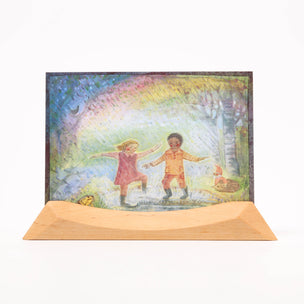 Colorful illustration of two children standing under a rainbow with a wooden base.