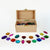 Wooden box with colorful gemstones on a white background