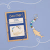 Cotton Twist shark keyring kit with wooden shark charm and colorful beads on a blue background