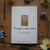 Note with 'Forget-me-not' design and text on a wooden surface with flowers