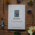 Card with 'Mallow' design and text on a wooden surface with flowers