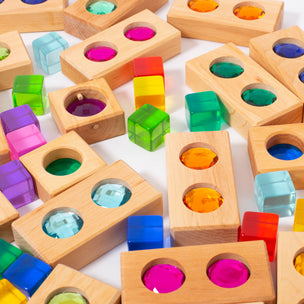 Colorful wooden blocks with transparent inserts on a white background