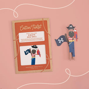 Pirate peg doll kit with packaging on a pink background