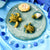 Life cycle of a sea turtle depicted with felt toys on a blue background