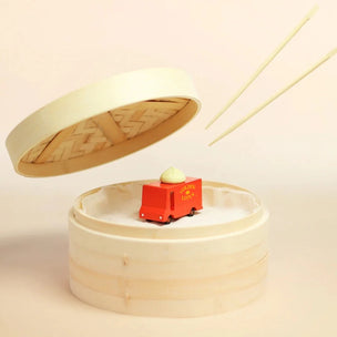 Candylab red toy Dumpling van with a dumpling on the roof, placed in a traditional steamer with chopsticks ready to grab it! | Conscious Craft